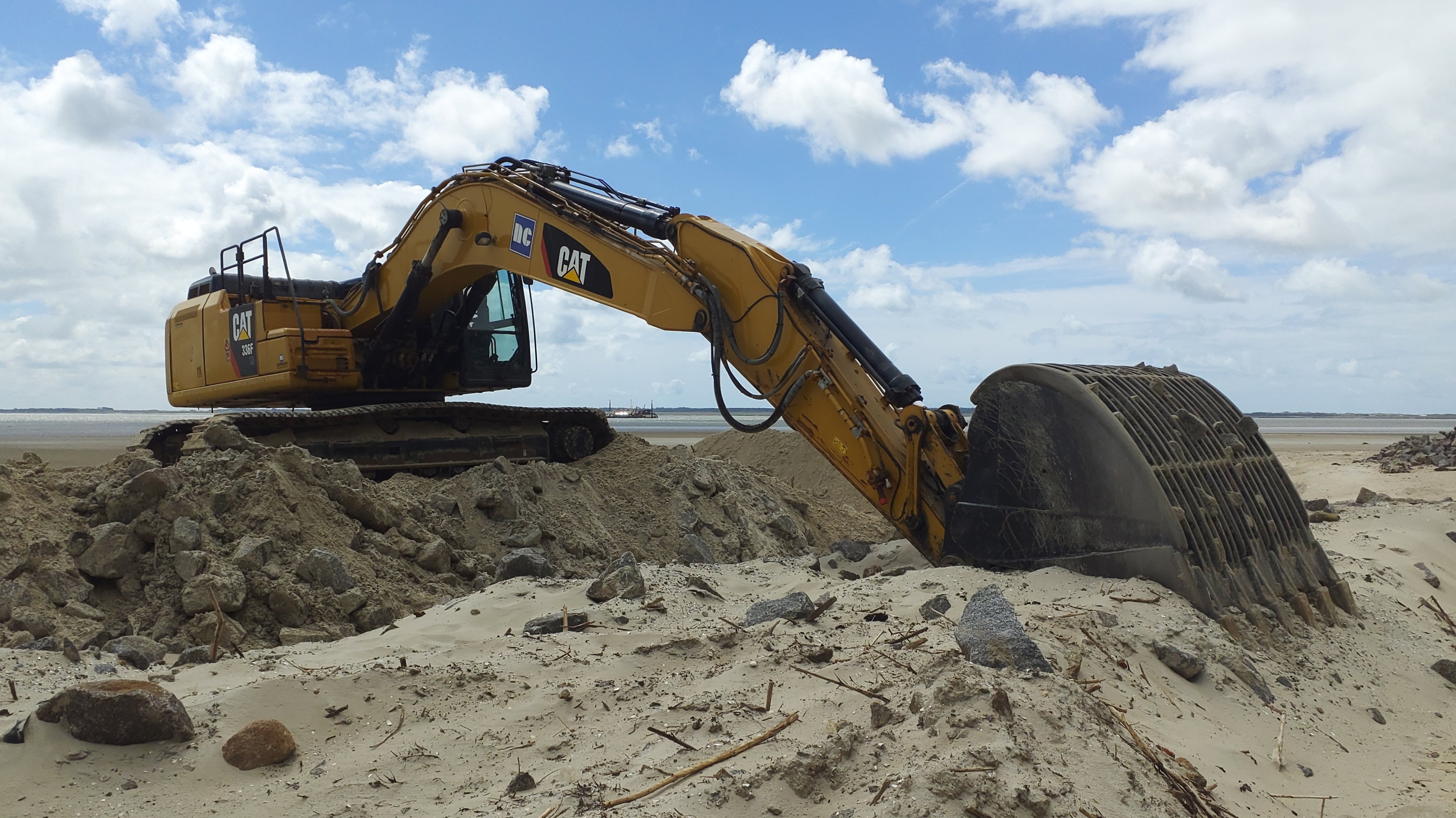 A shovel excavator on the beach.