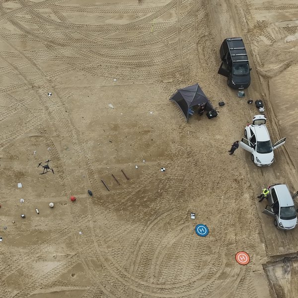 Aerial view of a multicopter drone over the test site. Different types of beach litter are placed on the ground. 