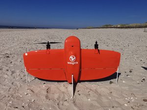 A ready-to-launch drone on a beach.
